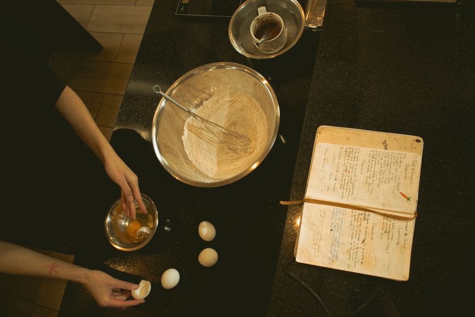 A kitchen scene of baking with ingredients and an open recipe book.